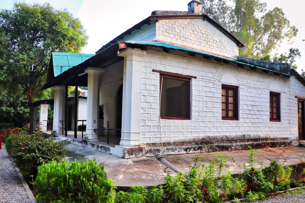Jim Corbett to Kainchi Dham Distance: Route via Nainital, Taxi Fare and Bus Options White stone bungalow with a green metal roof and a pillared veranda, Corbett House at the Jim Corbett Museum, Kaladhungi