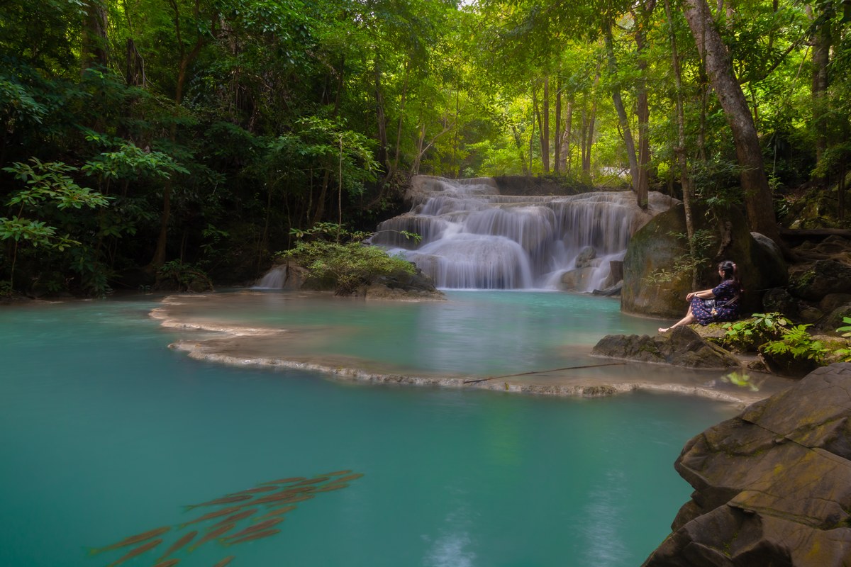 Turquoise pools and limestone cascades at the first tier of Erawan Waterfall in Erawan National Park, Kanchanaburi