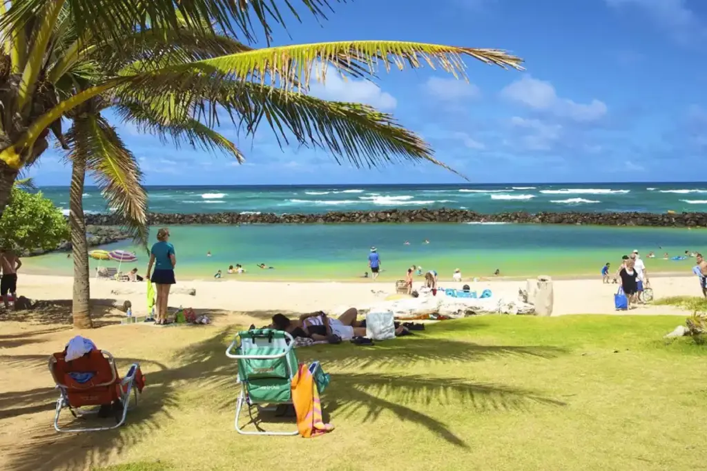 Kauai Trip Planning Tips: Must-See Trails & Beaches family having fun at the protected area of lydgate beach park