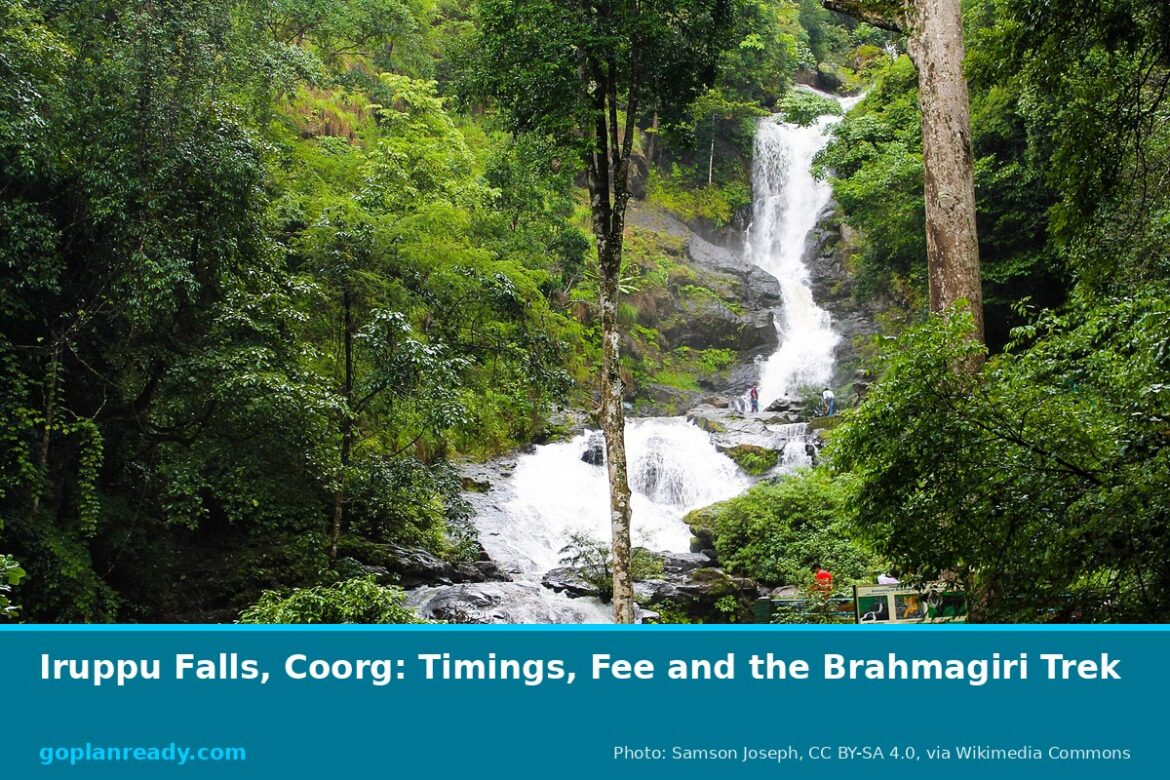 Iruppu Falls in Coorg, Karnataka, a tall waterfall dropping through green forest, with visitors near the viewing steps, and the title Iruppu Falls, Coorg: Timings, Fee and the Brahmagiri Trek