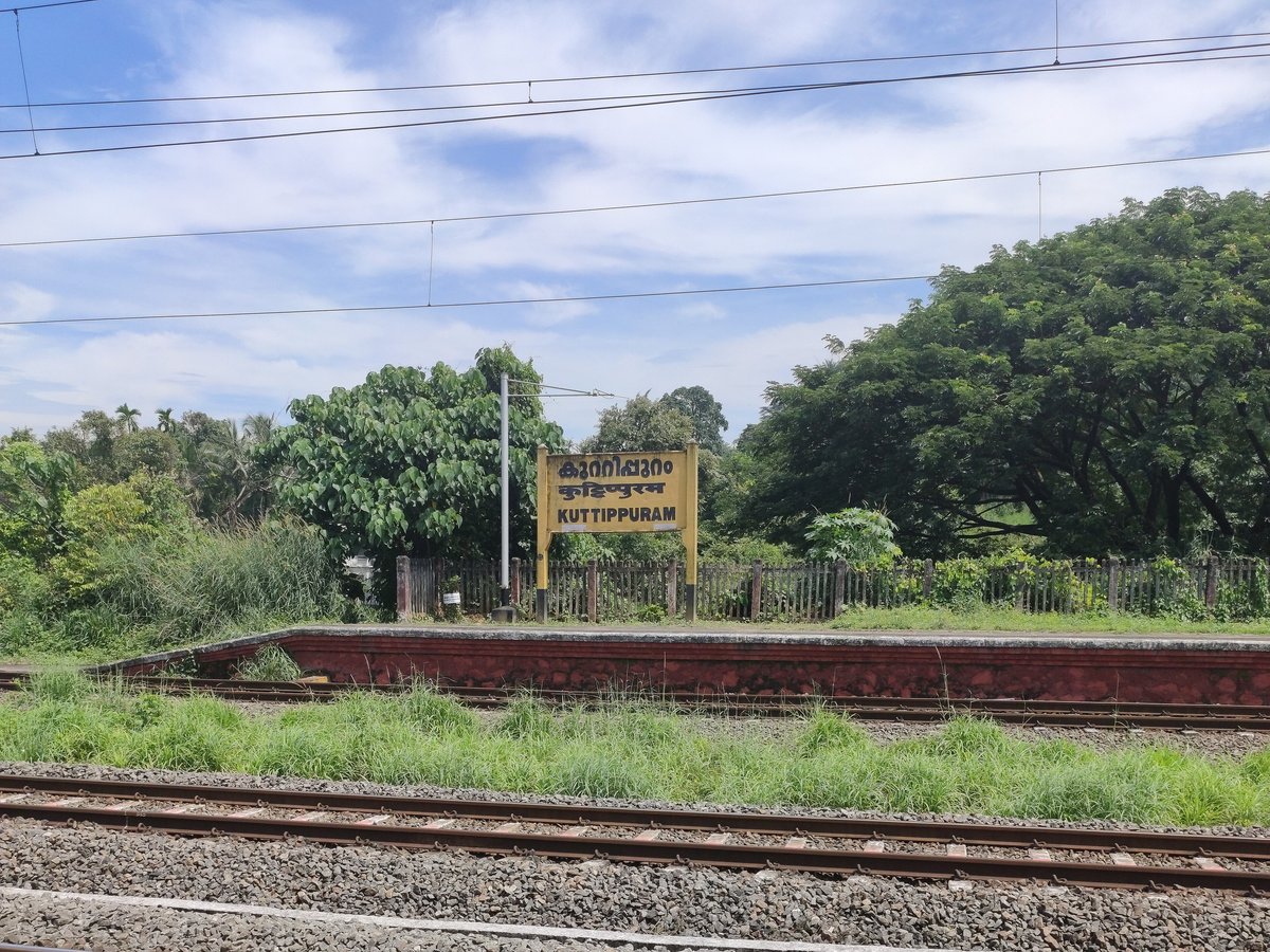Flora Fantasia Amusement Park Ticket Price 2026: Rates, Timings, Rides and How to Reach (Valanchery, Malappuram) Kuttippuram railway station platform in Kerala with the yellow station name board, railway track and green trees