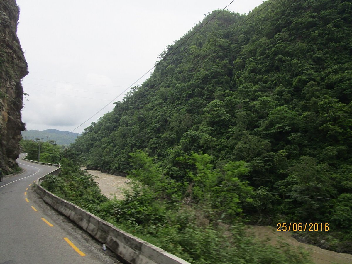 Kathmandu to Pokhara Distance: By Road, Bus Fare and Flight Time The two-lane Prithvi Highway curving between a rock cliff and a steep forested hillside above a muddy river near Aanbu Khaireni, Nepal