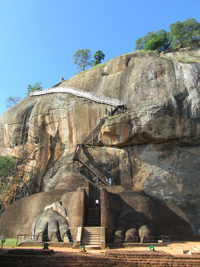 Sigiriya Entrance Fee for Foreigners, SAARC (India) Visitors and Children Steel staircase rising up the rock face of Sigiriya from between the two giant stone lion's paws on the Lion Platform